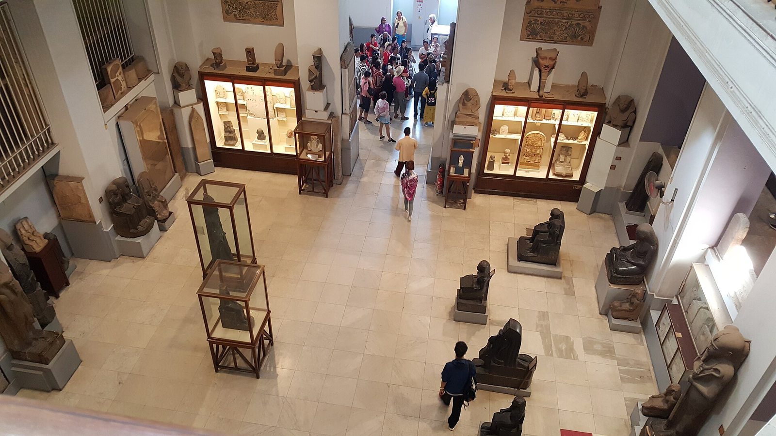 Dense Egyptian Museum gallery viewed from a visitor route
